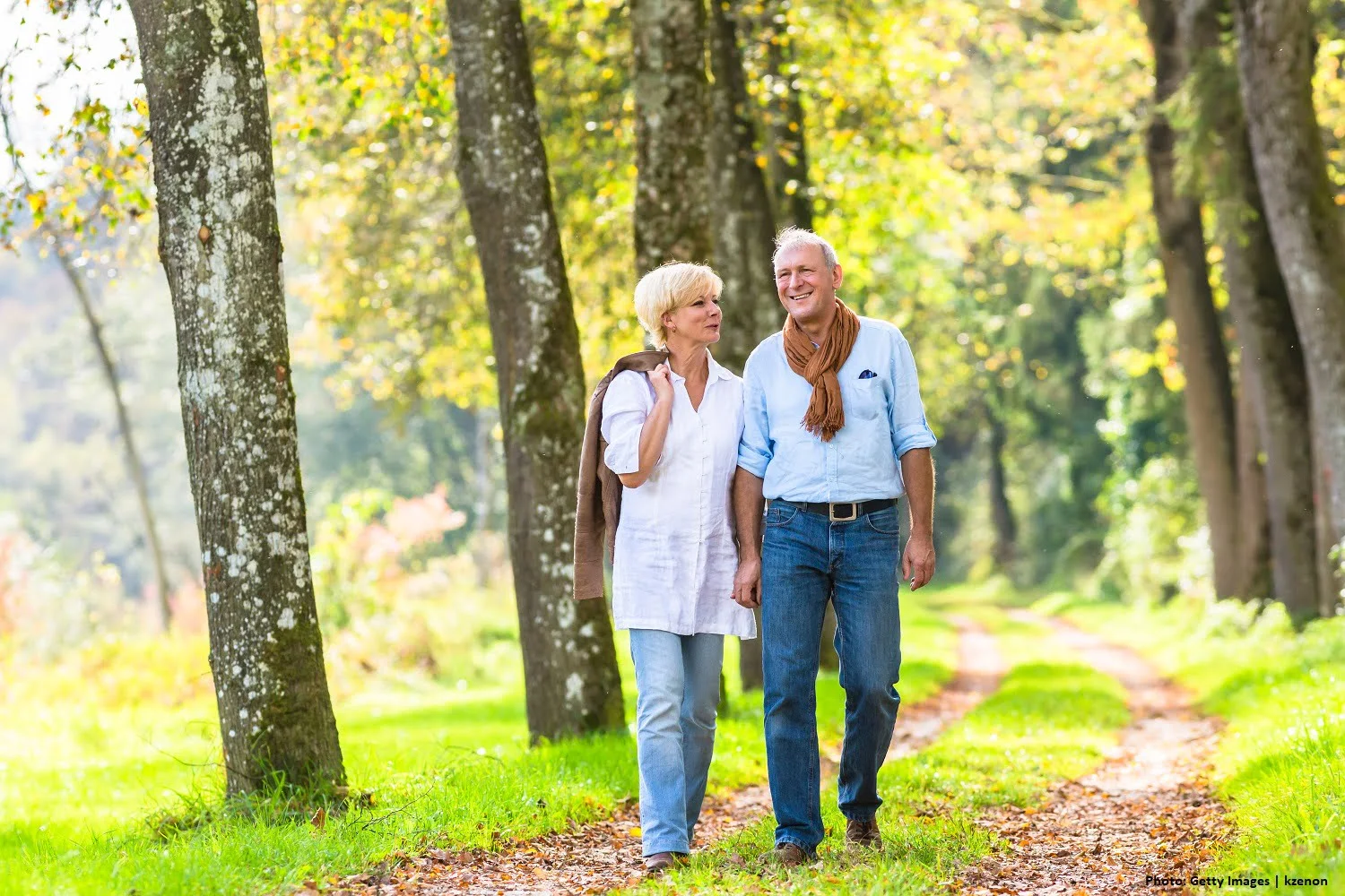 Senior couple having leisure walk in woods