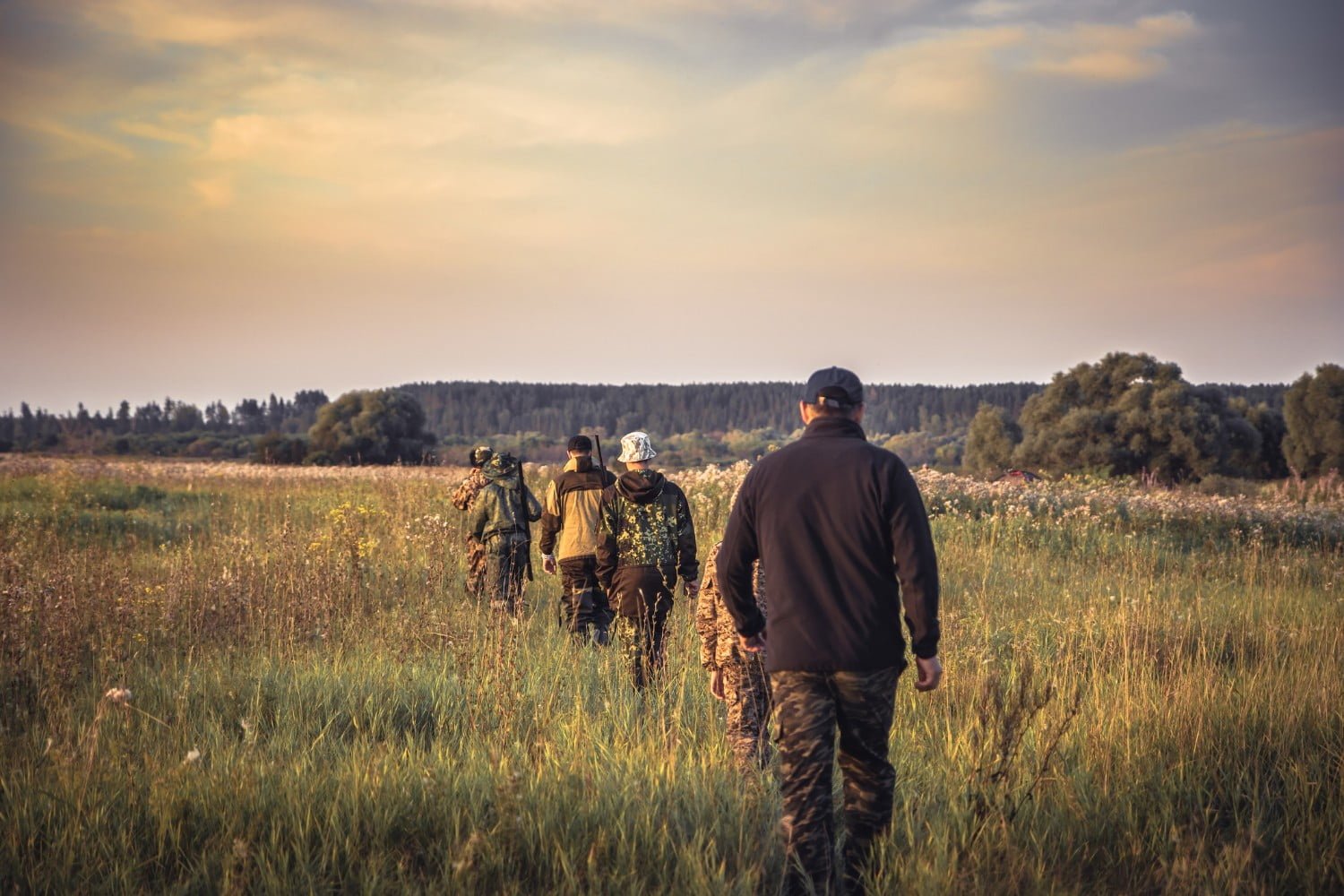 Hunters walking in the grass on their way to their hunt | Hunting Clubs in Ohio
