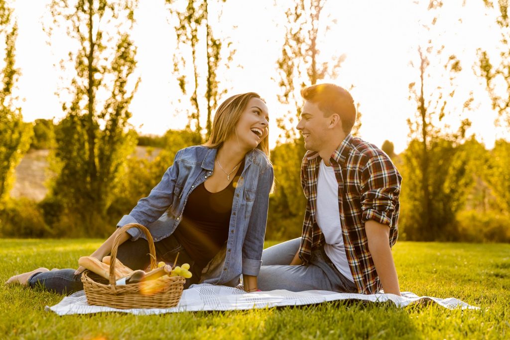Shot of a beautiful couple on the park making a picnic and having fun during memorial day weekend in Ohio
