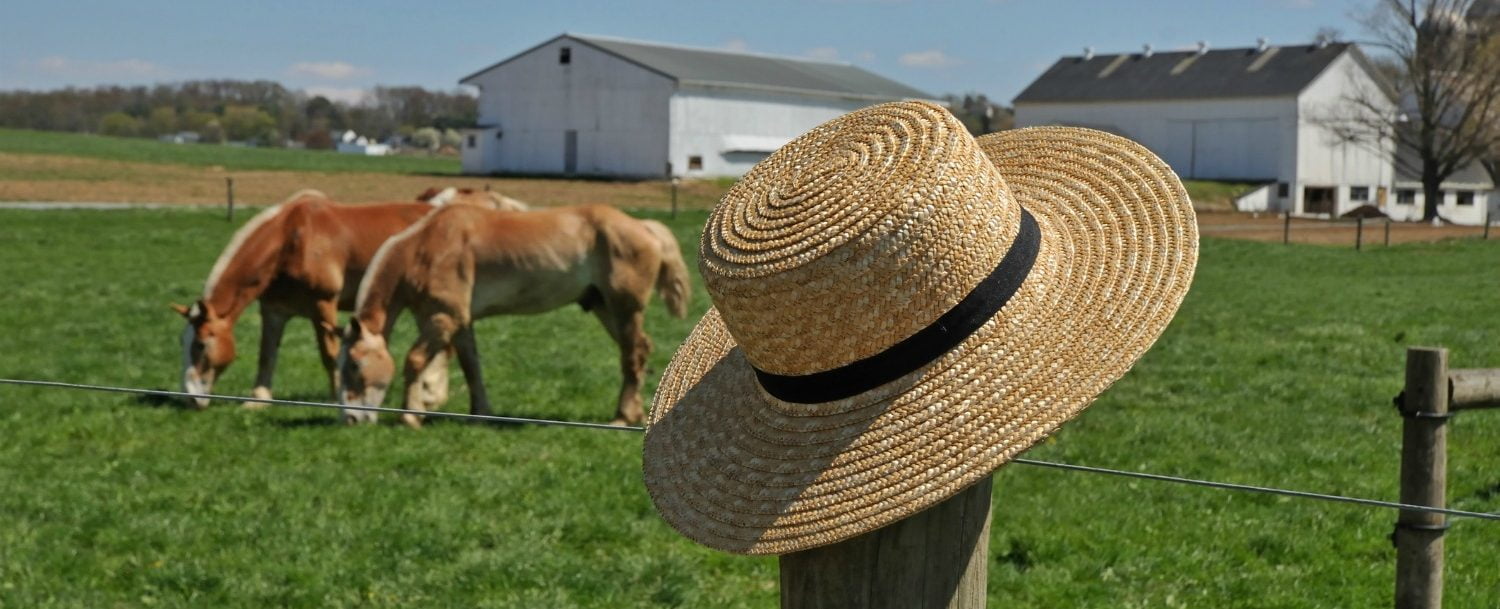 Straw Hat on a fence in the countryside | Rustic Getaway in Ohio
