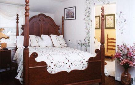 View of the Bed at the Garden Manor House Room at the Hideaway Inn