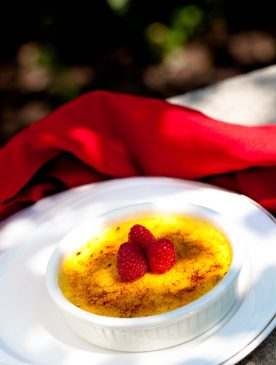 View of a delicious raspbarry desert on a white plate on the balcony